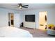Spacious bedroom with a modern dresser, adjacent bathroom, and access to the laundry room at 4178 Eagle Island St, Las Vegas, NV 89130