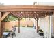 A backyard with a wood pergola with a paved patio, lawn, and block wall for privacy at 4178 Eagle Island St, Las Vegas, NV 89130