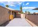 Backyard with covered patio, storage, block wall and gate at 4274 Rollingstone Dr, Las Vegas, NV 89103