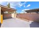 Backyard with covered patio and block wall to gated entry at 4274 Rollingstone Dr, Las Vegas, NV 89103