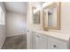 Bathroom vanity next to doorway to carpeted room with window at 4274 Rollingstone Dr, Las Vegas, NV 89103