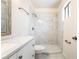 Bright bathroom featuring a new vanity, toilet, and shower with marble-patterned tile surround at 4274 Rollingstone Dr, Las Vegas, NV 89103