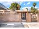 Front of home behind block wall, gated entry and desert landscaping at 4274 Rollingstone Dr, Las Vegas, NV 89103