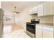 Bright kitchen with white cabinets and stainless steel appliances at 4274 Rollingstone Dr, Las Vegas, NV 89103