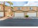 Two-story townhome featuring attached garages and desert landscaping for a low-maintenance appeal at 5249 Wave Dancer Ln, Las Vegas, NV 89118