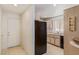 Functional kitchen with laminate floors and a side-by-side black refrigerator at 5249 Wave Dancer Ln, Las Vegas, NV 89118