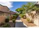 Beautiful walkway lined with mature landscaping and leading to residential buildings at 5249 Wave Dancer Ln, Las Vegas, NV 89118