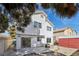 Exterior of home showcasing backyard, patio, the yard with a large tree, and a storage shed at 5636 Royal Castle Ln, Las Vegas, NV 89130