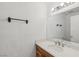Bathroom featuring a single vanity with a wooden cabinet and large mirror at 5636 Royal Castle Ln, Las Vegas, NV 89130