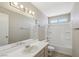Well-lit bathroom featuring a single sink vanity, an updated shower-tub combo, and neutral paint at 5636 Royal Castle Ln, Las Vegas, NV 89130