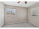 A cozy bedroom featuring neutral tones, carpet flooring and natural light from two windows at 5636 Royal Castle Ln, Las Vegas, NV 89130