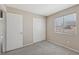 Cozy bedroom with gray carpet, bright window, and closet providing comfortable living space at 5636 Royal Castle Ln, Las Vegas, NV 89130