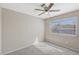 Neutral bedroom featuring carpet, ceiling fan, and bright natural light at 5636 Royal Castle Ln, Las Vegas, NV 89130