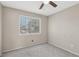 Bedroom featuring neutral paint, gray carpet, and a bright window with a view at 5636 Royal Castle Ln, Las Vegas, NV 89130