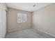 Bedroom featuring gray carpet, neutral paint, closet, and a bright window offering comfortable living space at 5636 Royal Castle Ln, Las Vegas, NV 89130
