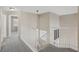 Upstairs hallway with gray carpet and white railings leading to the bedrooms and stairs at 5636 Royal Castle Ln, Las Vegas, NV 89130