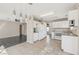 Large kitchen with bright tile floor, pendant lighting and modern appliances at 5636 Royal Castle Ln, Las Vegas, NV 89130