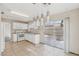 Spacious kitchen with tile flooring, white cabinets, and sliding glass door at 5636 Royal Castle Ln, Las Vegas, NV 89130