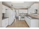 Well-lit kitchen featuring white appliances, cabinets, and tile floors at 5636 Royal Castle Ln, Las Vegas, NV 89130