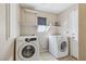 Functional laundry room with washer, dryer, and convenient shelving at 5636 Royal Castle Ln, Las Vegas, NV 89130