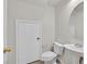 Clean half bathroom with a pedestal sink and a large mirror at 5717 Heineken Dr, North Las Vegas, NV 89031