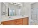 Bathroom featuring double sink vanity, a large mirror, and a shower with glass doors, creating an open space at 5717 Heineken Dr, North Las Vegas, NV 89031
