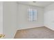 Cozy bedroom featuring neutral walls, carpeted floors, one window and large sliding door closet at 5717 Heineken Dr, North Las Vegas, NV 89031