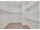 Walk-in closet with carpeted floor, white walls, and multiple shelves and racks for optimal storage at 5717 Heineken Dr, North Las Vegas, NV 89031