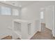 Upstairs hallway has carpeted floors and view of the adjacent rooms with lots of light at 5717 Heineken Dr, North Las Vegas, NV 89031