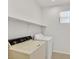 Laundry room with shelving above vintage washer and dryer at 5717 Heineken Dr, North Las Vegas, NV 89031
