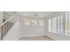 Upstairs living area with neutral carpet, bright natural light and white walls at 5717 Heineken Dr, North Las Vegas, NV 89031