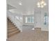 Bright and open living area features a staircase and abundant natural light from multiple windows at 5717 Heineken Dr, North Las Vegas, NV 89031