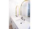 Bathroom vanity with double sinks, gold trimmed mirrors and black fixtures at 6170 W University Ave, Las Vegas, NV 89103