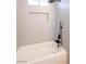 Clean bathroom featuring a tub, shower head and tiled wall at 6170 W University Ave, Las Vegas, NV 89103