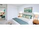 Stylish bedroom with a padded headboard, soft green bedding, and wooden nightstands at 6170 W University Ave, Las Vegas, NV 89103