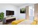 Bright bedroom features a large window, TV, and modern decor at 6170 W University Ave, Las Vegas, NV 89103