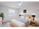 Comfortable bedroom with modern furnishings, natural light, and calming white walls at 6170 W University Ave, Las Vegas, NV 89103