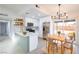 Modern kitchen with stainless appliances, a breakfast bar, and adjacent dining area at 6170 W University Ave, Las Vegas, NV 89103