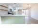 Bright kitchen features white cabinets, stainless steel appliances, and a light green accent island at 6170 W University Ave, Las Vegas, NV 89103