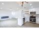 Open-concept living space with a modern kitchen, electric fireplace, and sleek finishes at 6170 W University Ave, Las Vegas, NV 89103
