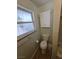 Standard bathroom with a white toilet, vanity, frosted window and wall storage cabinet at 6284 Explorer Dr, Las Vegas, NV 89103