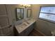 Well-lit bathroom featuring double sinks, tile floors, and modern fixtures at 6284 Explorer Dr, Las Vegas, NV 89103