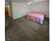 Large carpeted bedroom with a ceiling fan and neutral color scheme at 6284 Explorer Dr, Las Vegas, NV 89103