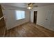 Bedroom with wood-look flooring, ceiling fan, a window with blinds and a closet at 6284 Explorer Dr, Las Vegas, NV 89103