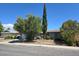 Exterior of home with drought tolerant landscaping, and shade trees at 6284 Explorer Dr, Las Vegas, NV 89103
