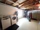 Laundry area in garage with washer, dryer, water heater, and storage shelves at 6284 Explorer Dr, Las Vegas, NV 89103