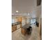 Open kitchen with a granite island, tile floors, and stainless steel appliances at 6284 Explorer Dr, Las Vegas, NV 89103