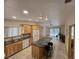 Well-lit kitchen with a central island, bright cabinets, and tiled flooring at 6284 Explorer Dr, Las Vegas, NV 89103