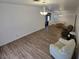 Bright and airy living room featuring modern furnishings and wood-look flooring at 6284 Explorer Dr, Las Vegas, NV 89103
