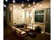Outdoor living space featuring comfortable seating, string lights, and a stylish umbrella at 704 Webber Park St, Henderson, NV 89011